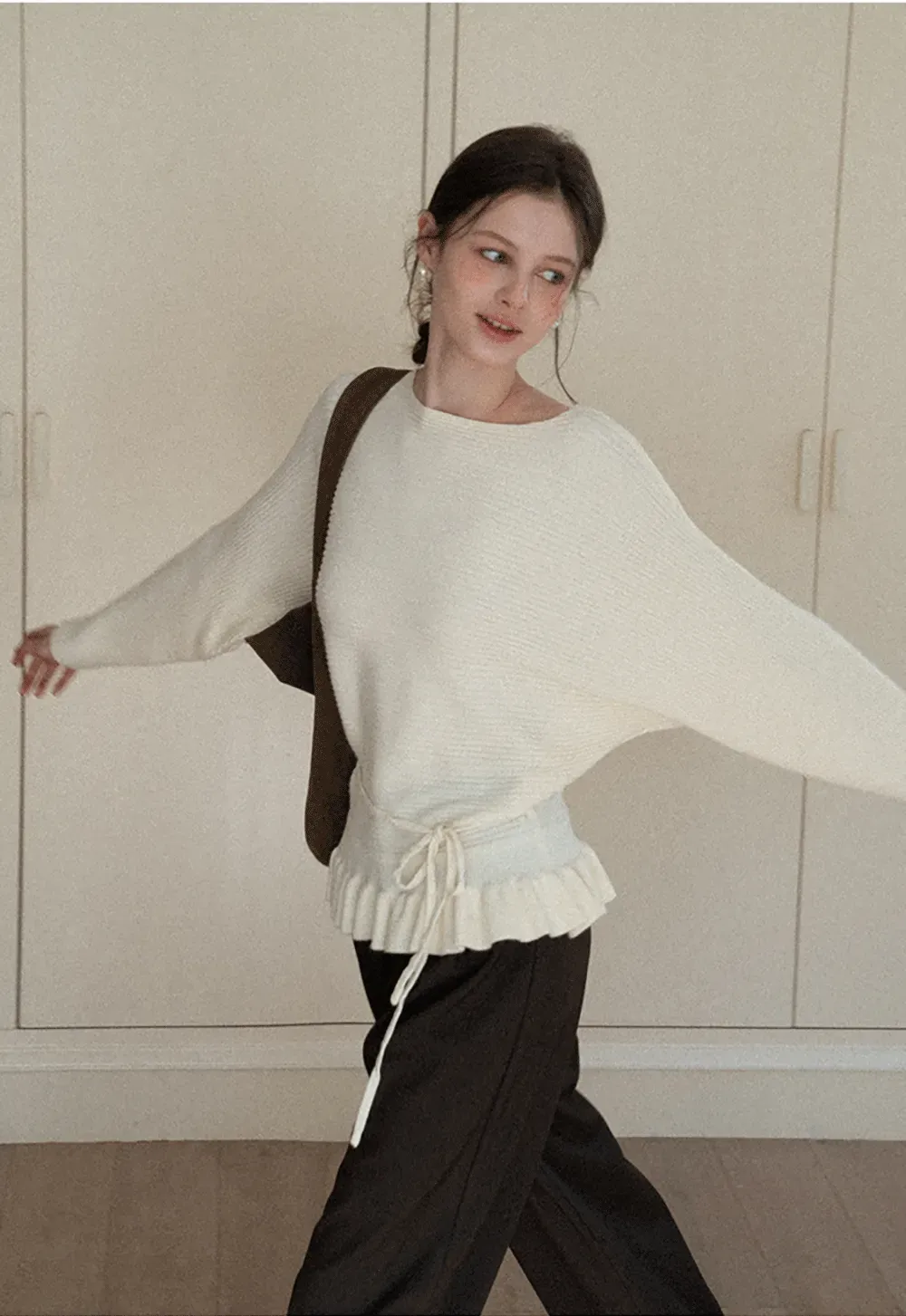 Ribbed knit sweater with tie back and flared hem design