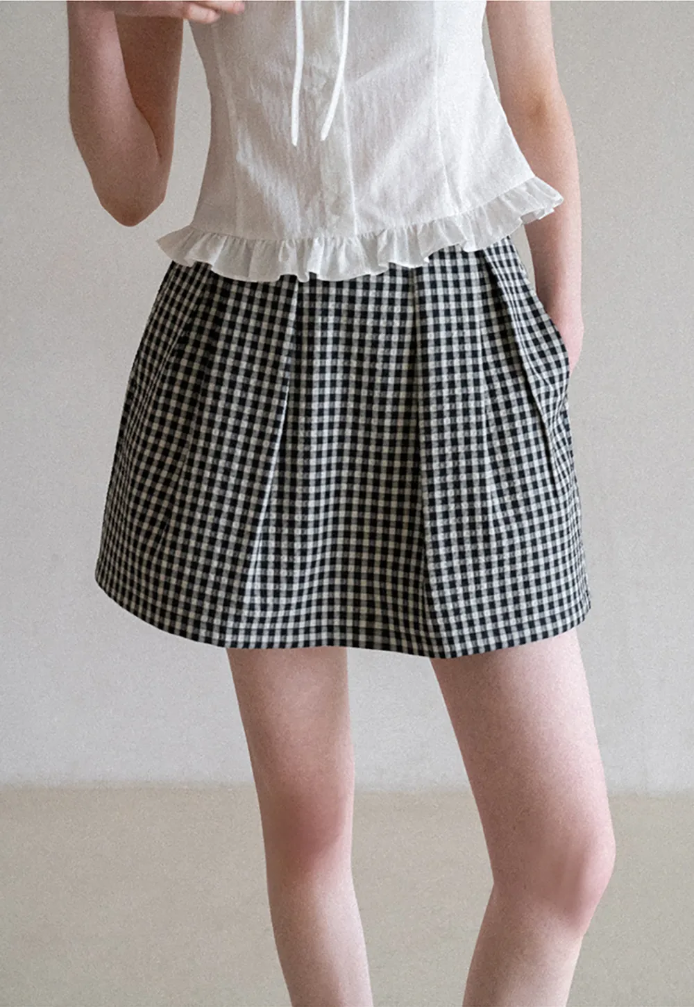 Plaid skirt with pleats and ruffled top