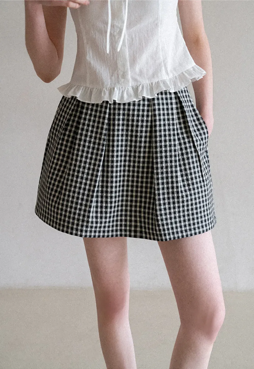 Plaid skirt with pleats and ruffled top