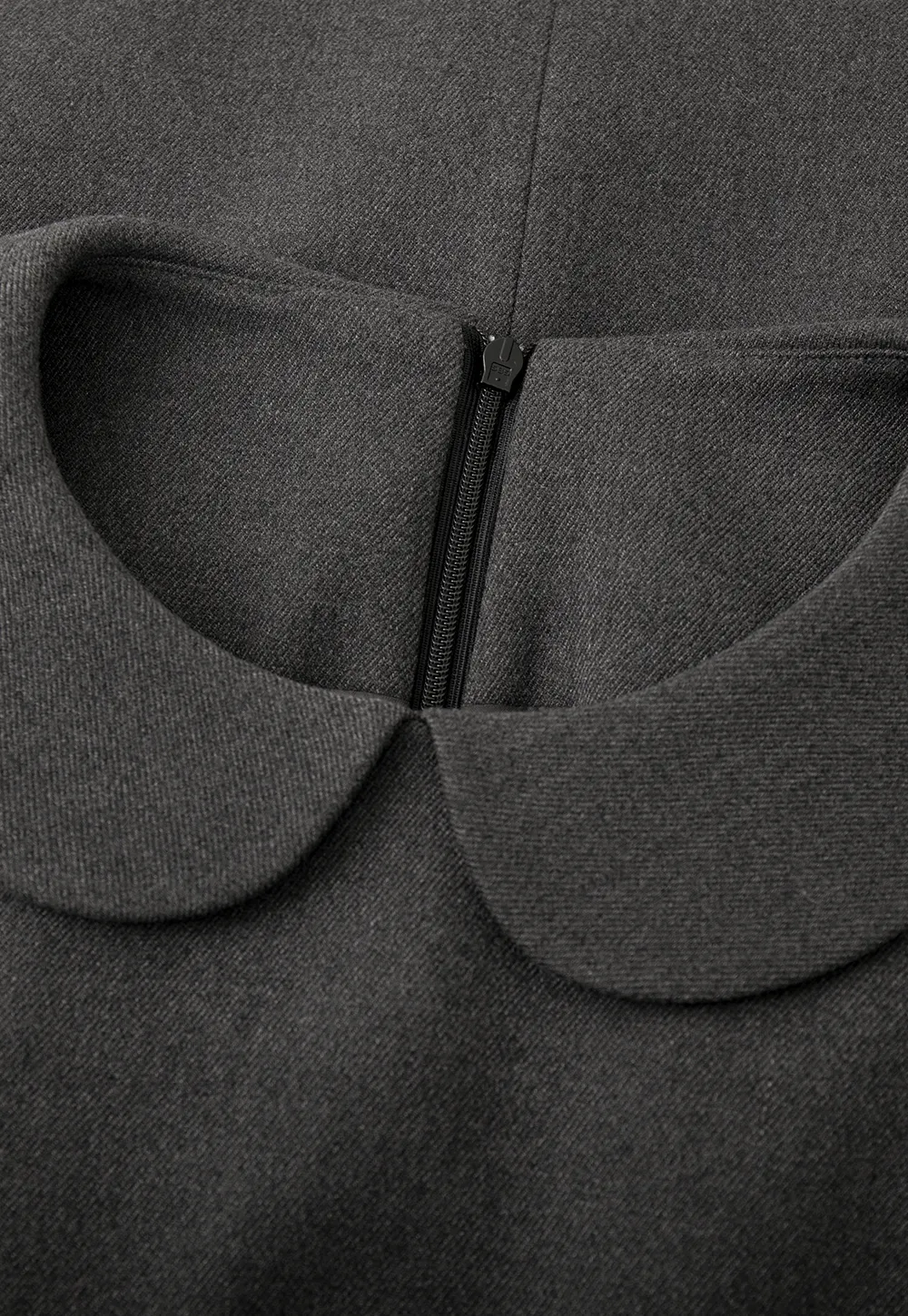 Elegant sleeveless dress with collar layered over polka dot top