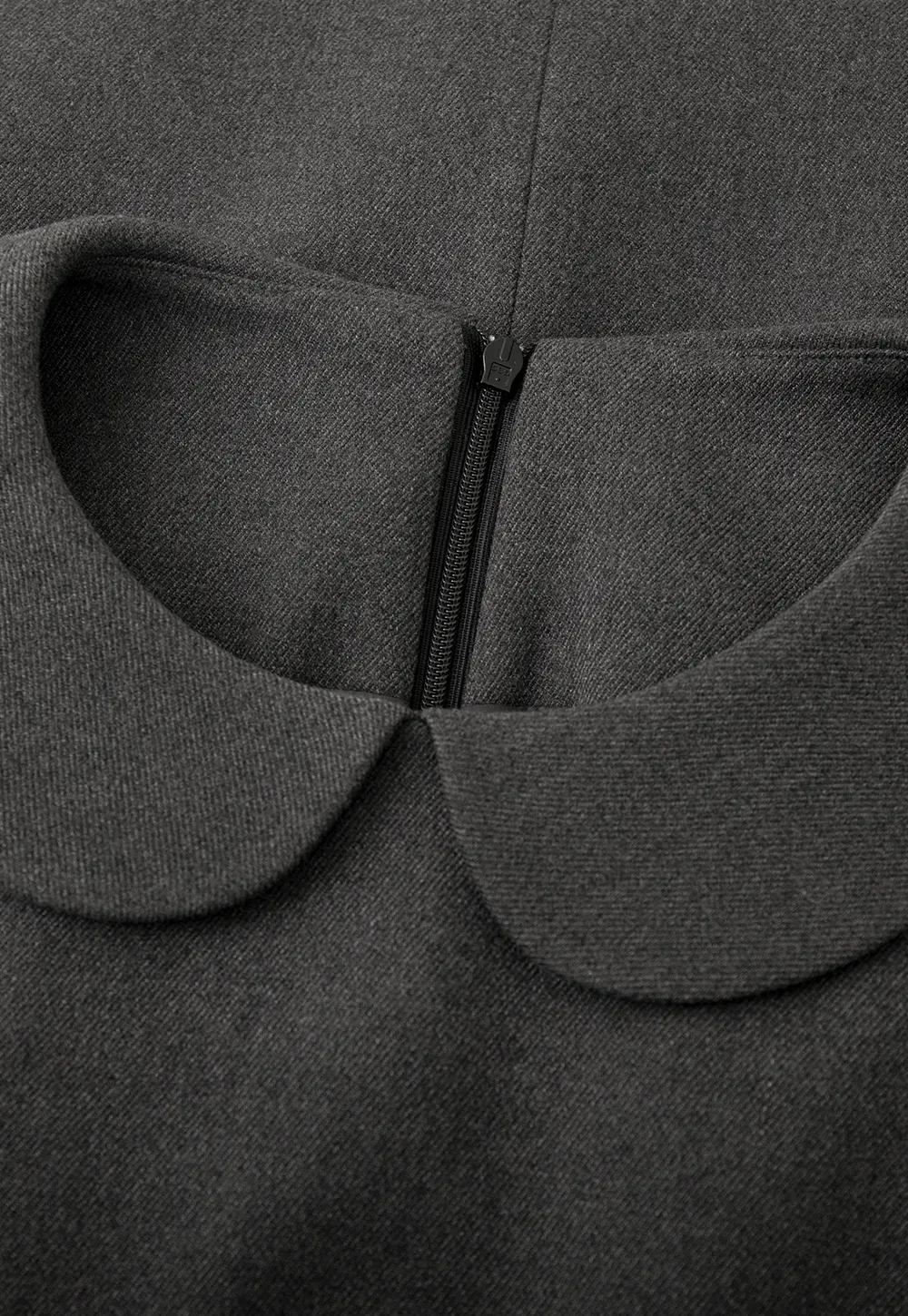 Elegant sleeveless dress with collar layered over polka dot top