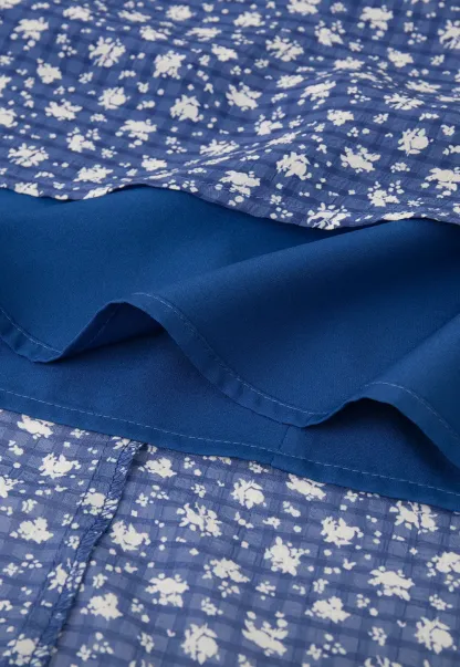 Halter neck dress with floral print and lace trim