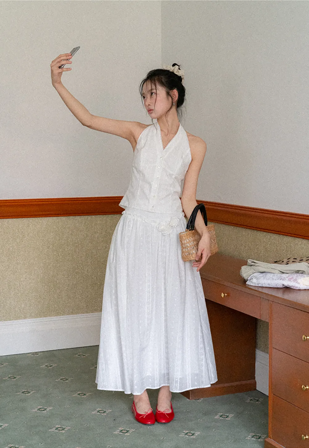 Halter neck sleeveless top with buttons and pleated skirt