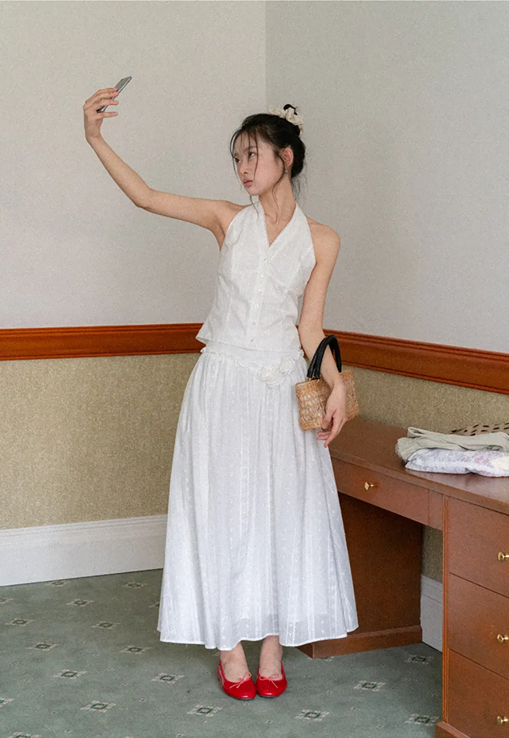 Halter neck sleeveless top with buttons and pleated skirt