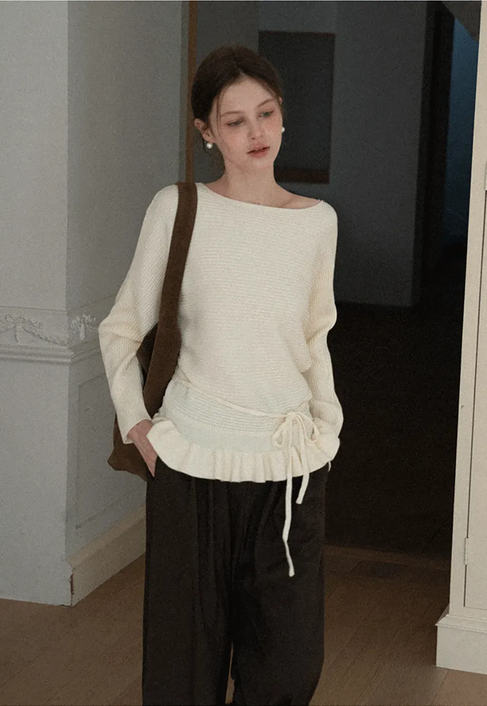 Ribbed knit sweater with tie back and flared hem design