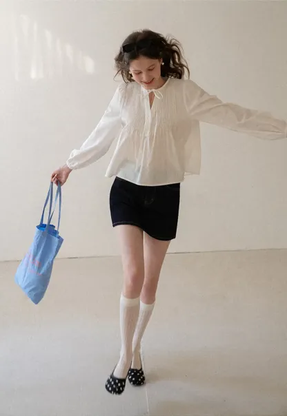 Pleated blouse with tie neck and long sleeves