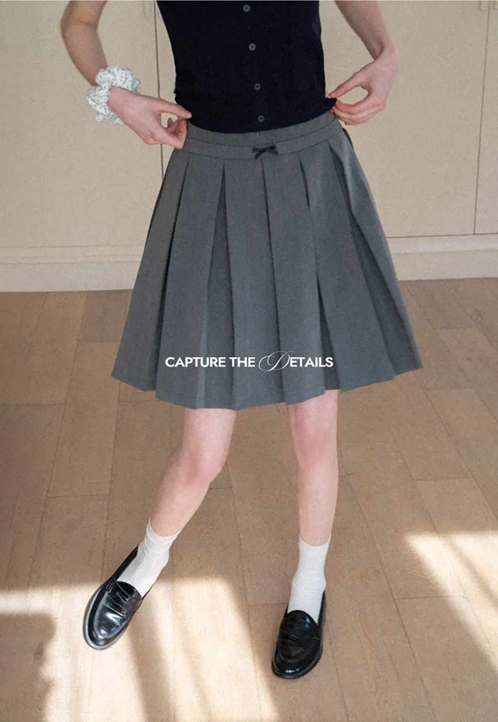 Pleated skirt with front bow detail