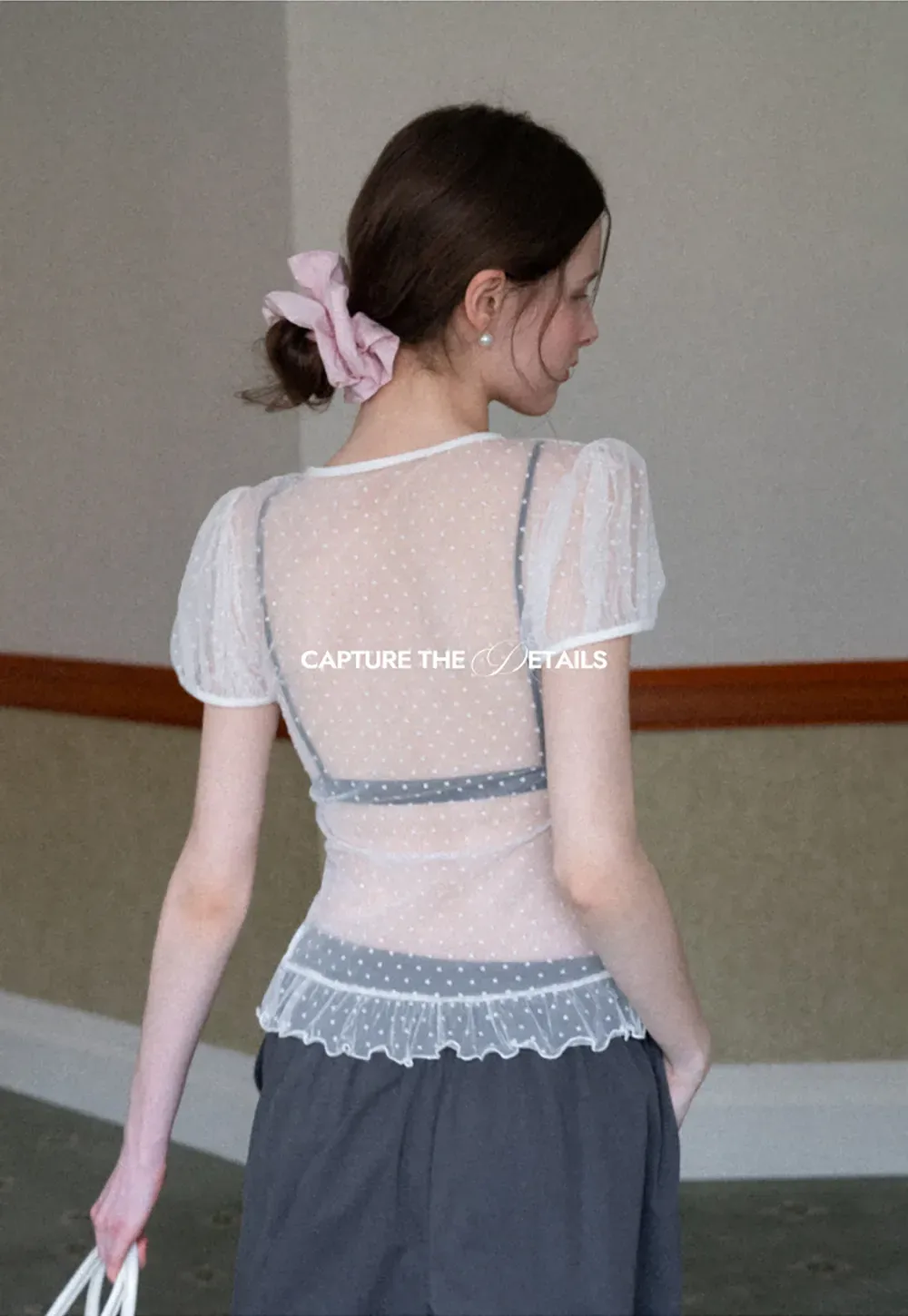 Sheer polka dot top with ruffled hem and puff sleeves