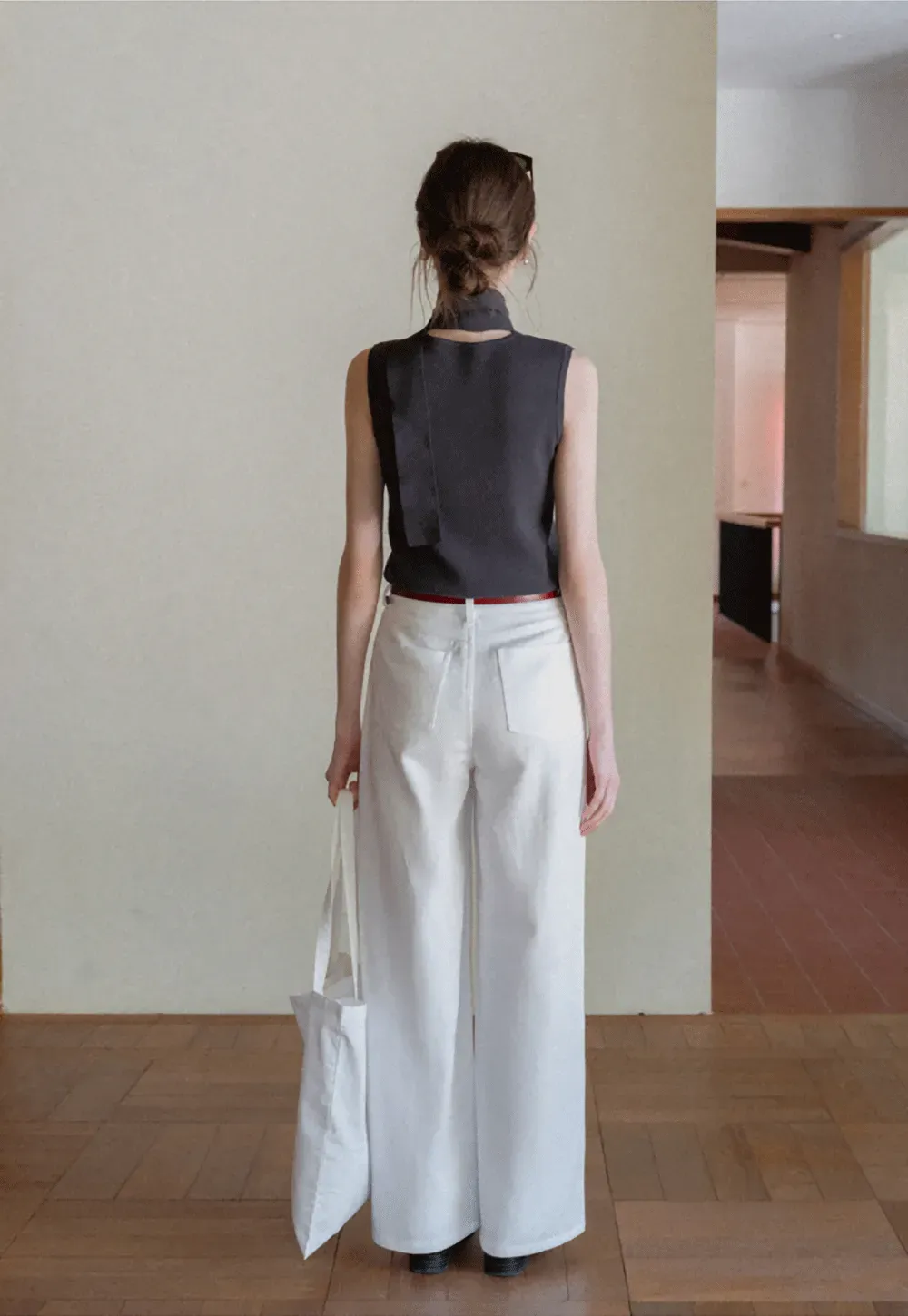 Sleeveless high neck knit top with side tie detail