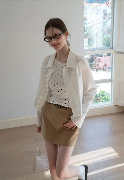 Short jacket with ruffled front placket and collar
