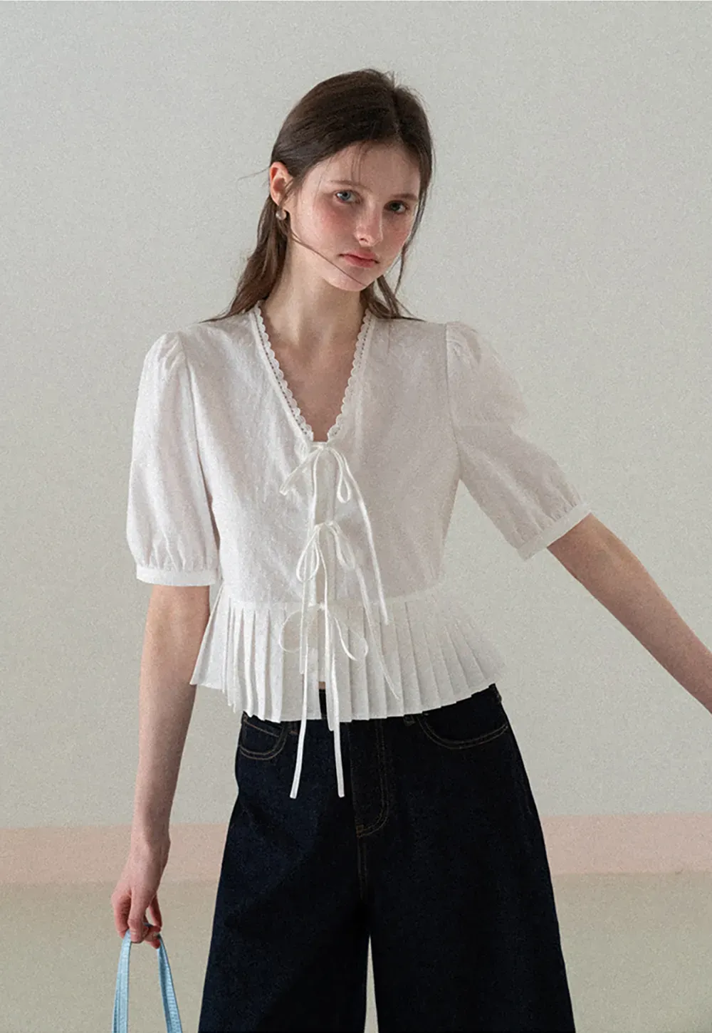 V neck short sleeve blouse with pleated hem and tie front