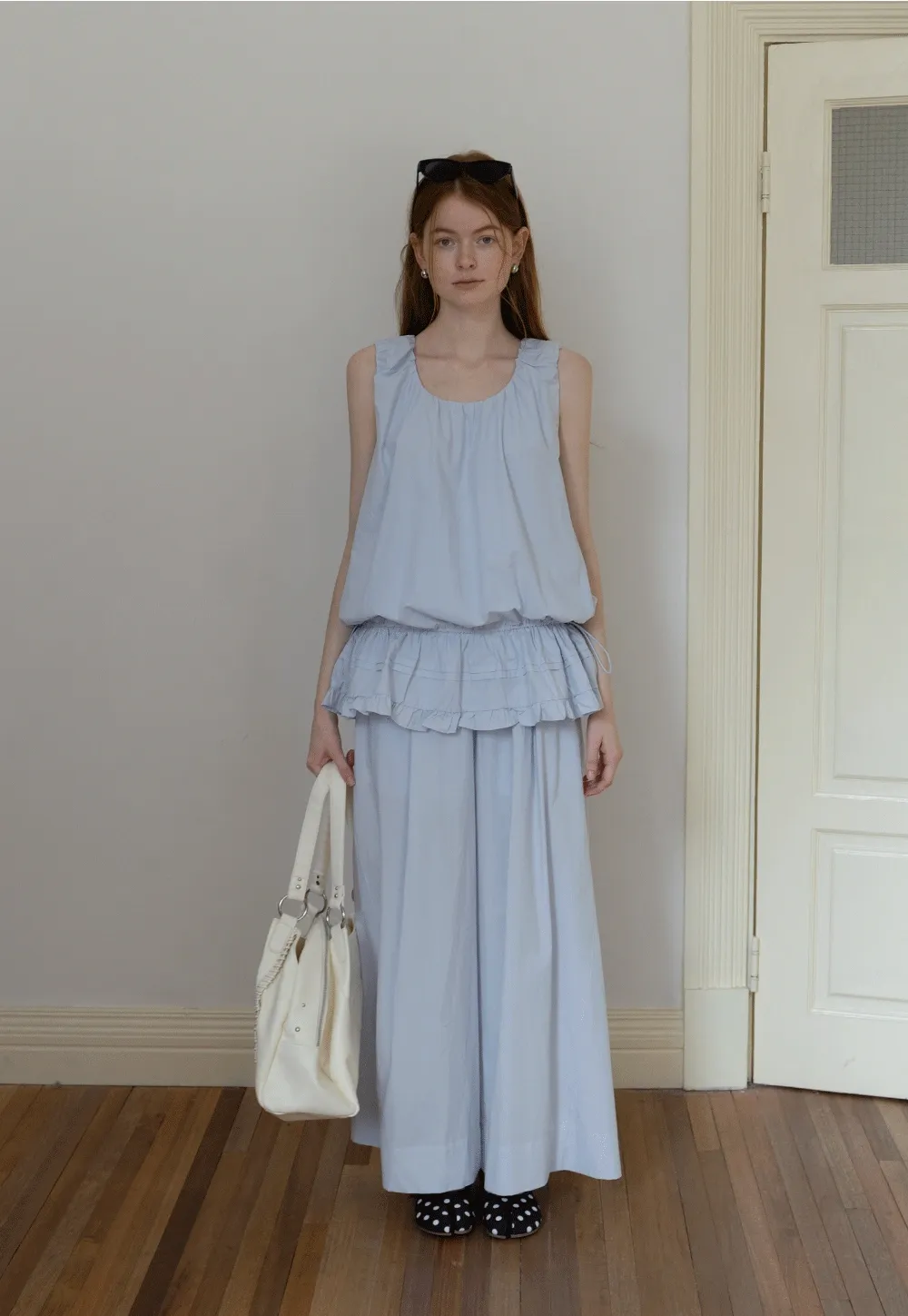 Sleeveless layered top and wide-leg pants