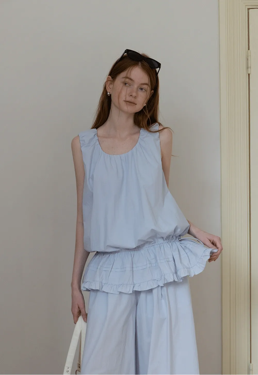 Sleeveless layered top and wide-leg pants