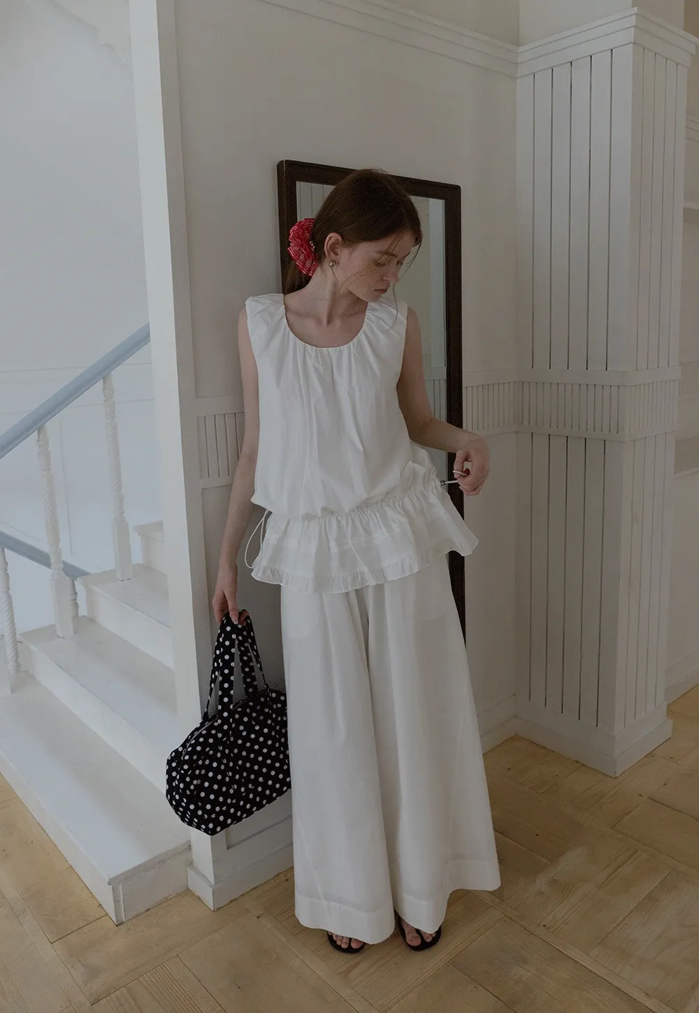 Sleeveless layered top and wide-leg pants
