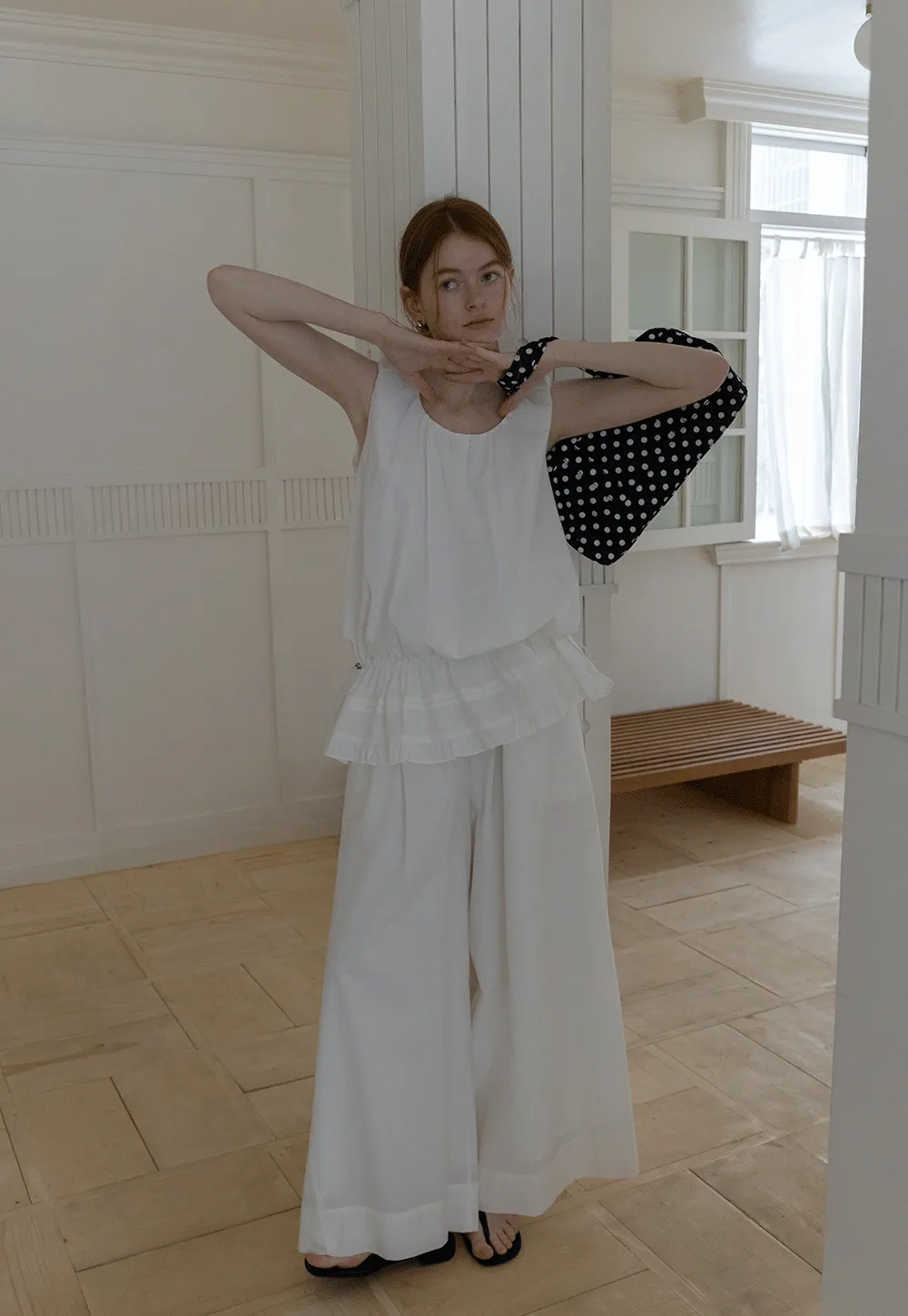 Sleeveless layered top and wide-leg pants