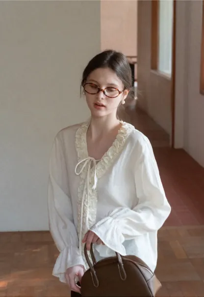 Long sleeve shirt with ruffled neckline and gathered cuffs