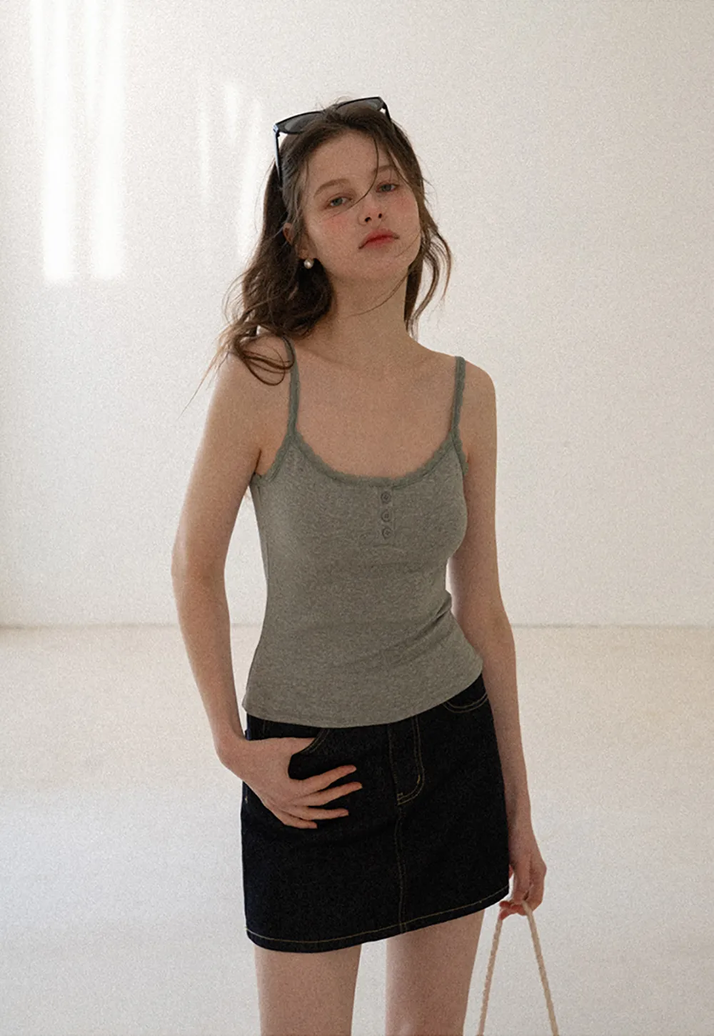 A-line denim skirt with front pocket design and adjustable waistband.