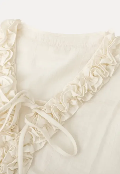 Long sleeve shirt with ruffled neckline and gathered cuffs