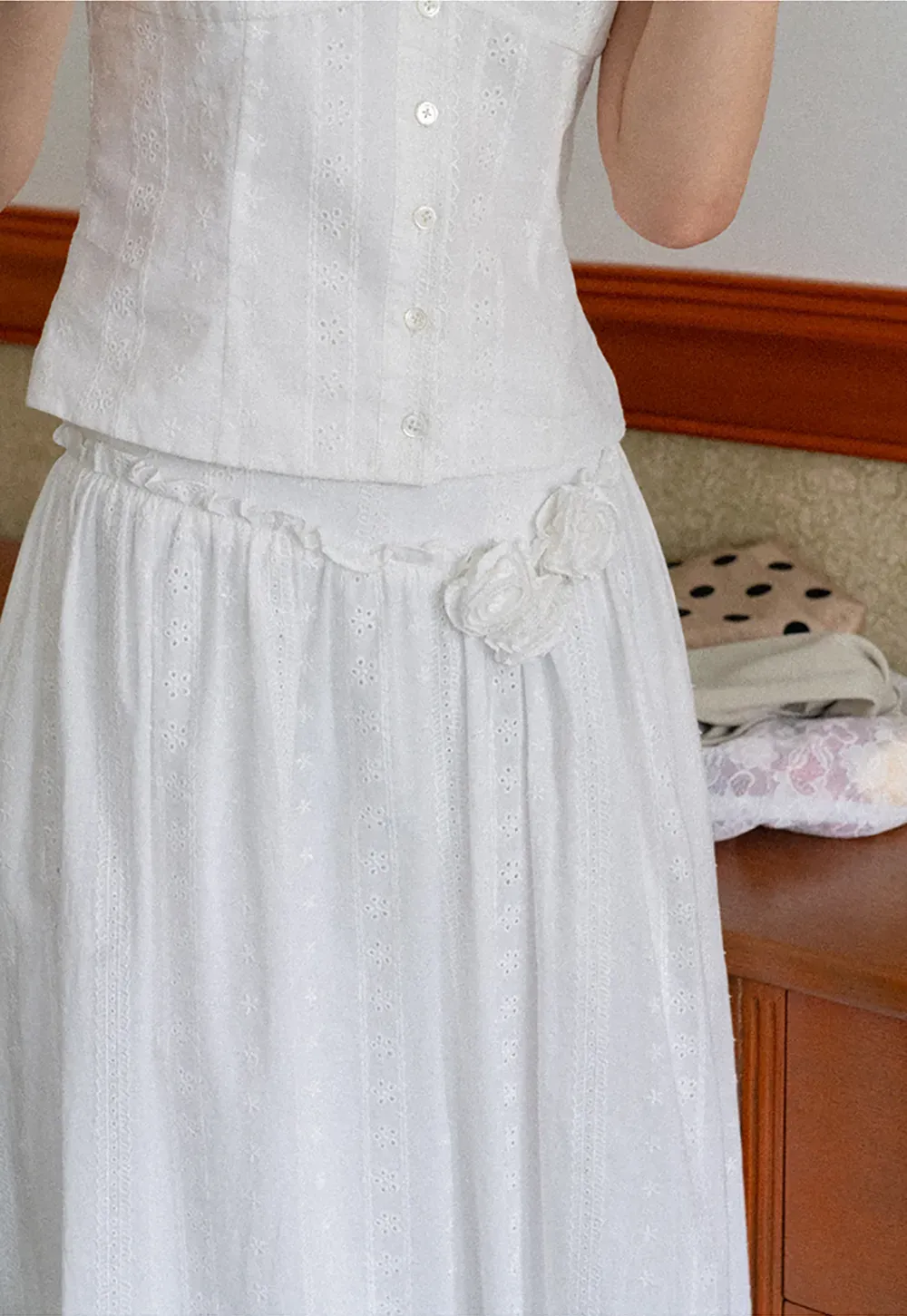 Halter neck sleeveless top with buttons and pleated skirt