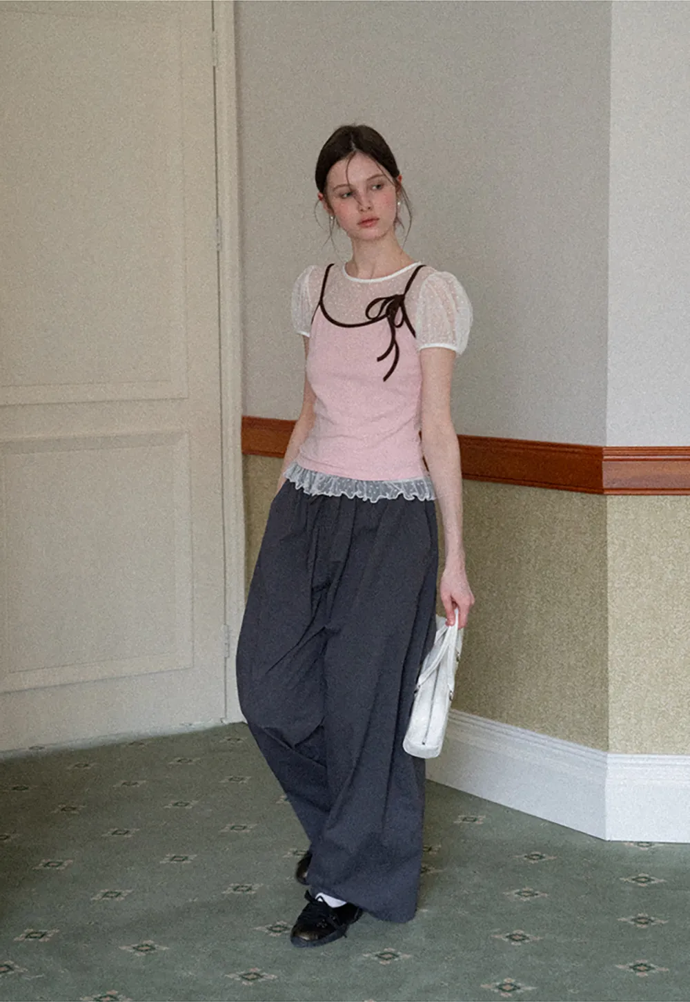 Sheer polka dot top with ruffled hem and puff sleeves