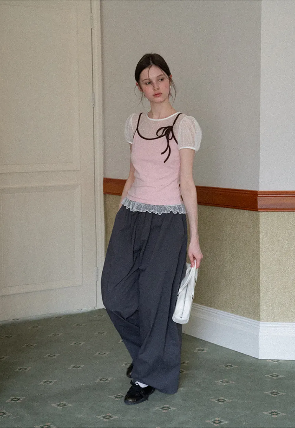 Sheer polka dot top with ruffled hem and puff sleeves