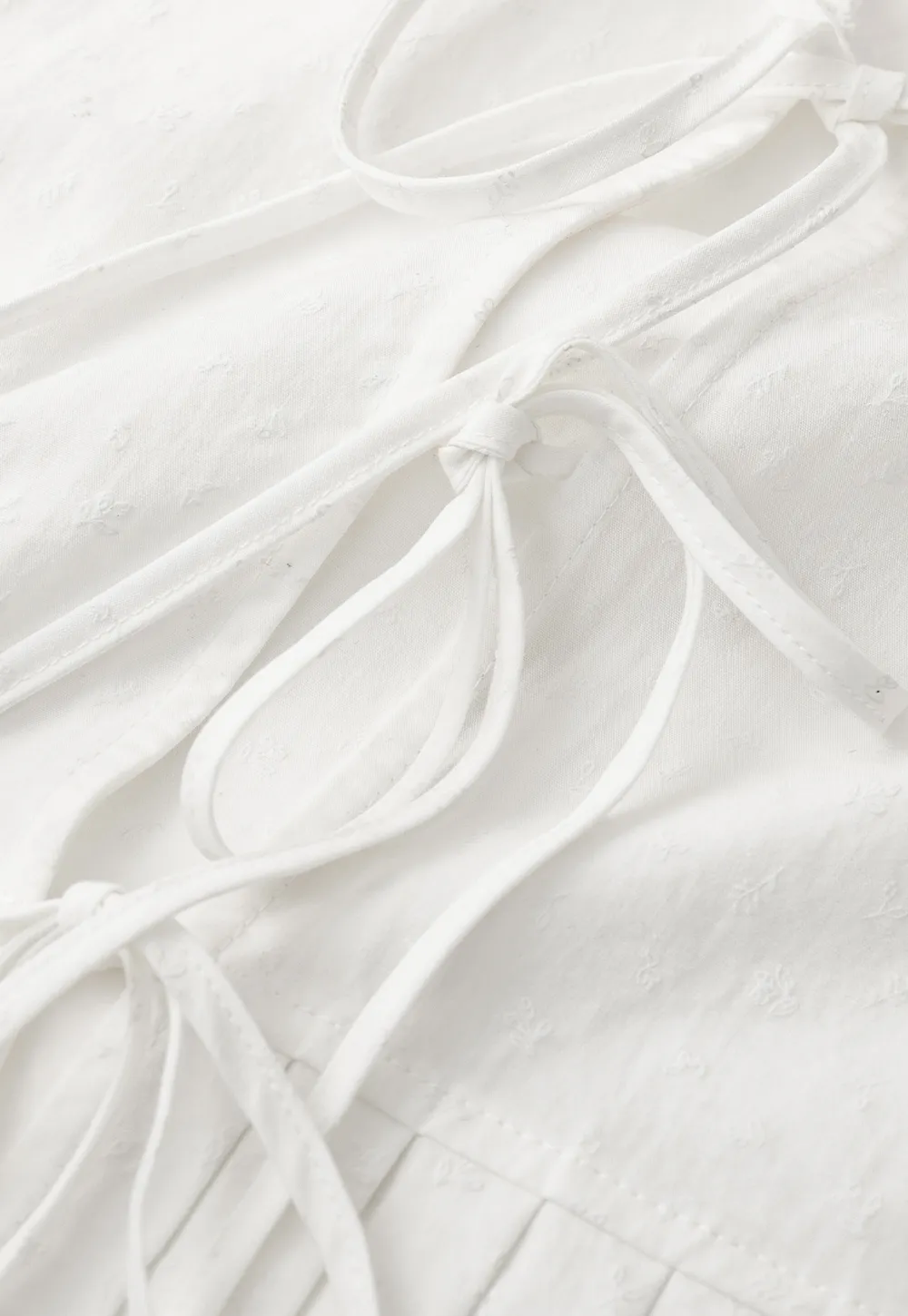 V neck short sleeve blouse with pleated hem and tie front