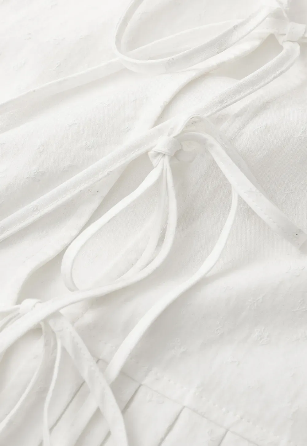 V neck short sleeve blouse with pleated hem and tie front