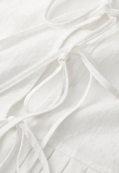 V neck short sleeve blouse with pleated hem and tie front