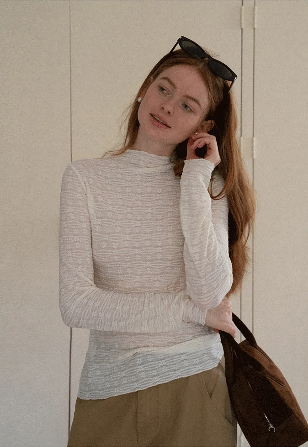 Elegant textured long sleeve top with subtle pattern design