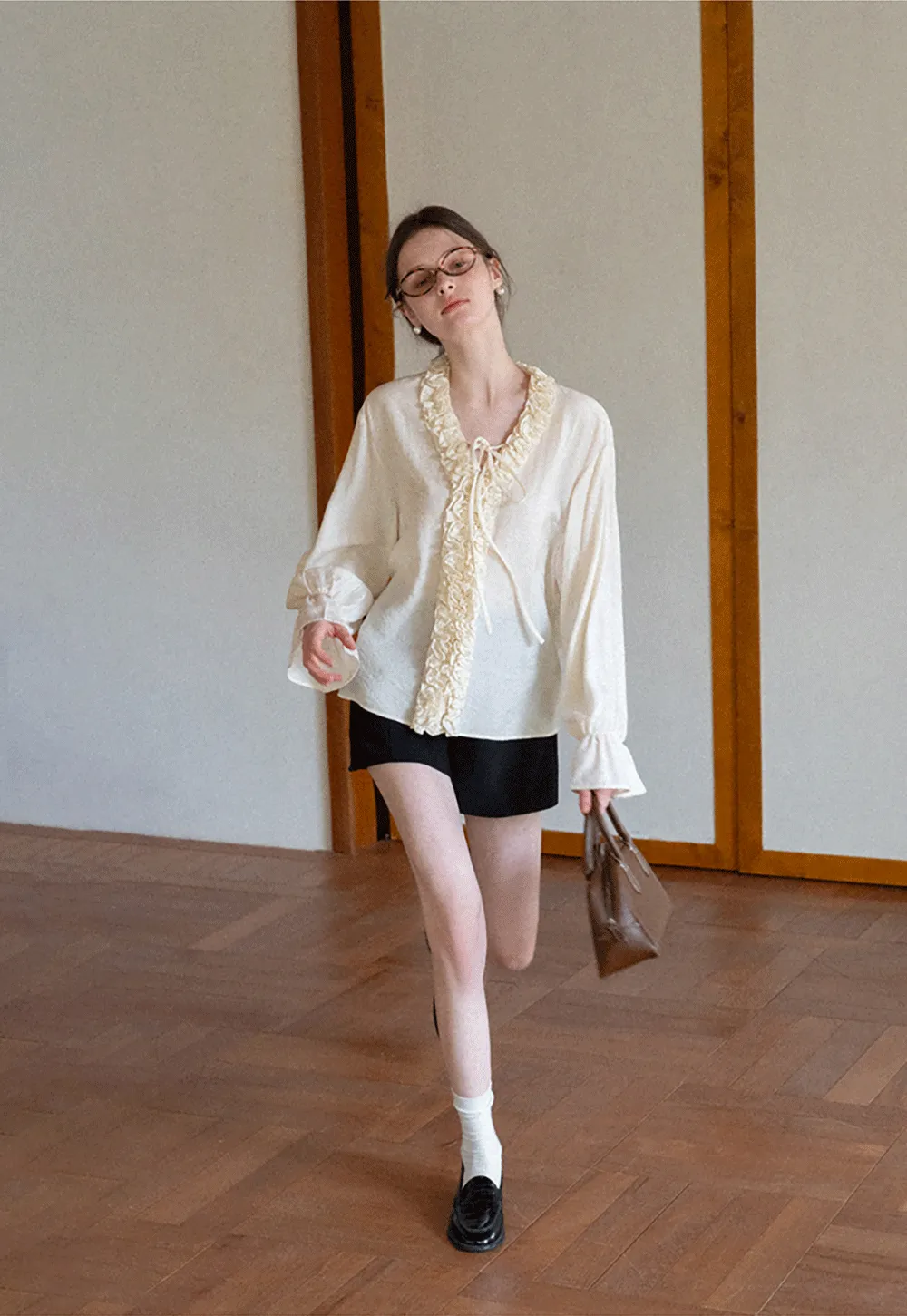 Long sleeve shirt with ruffled neckline and gathered cuffs