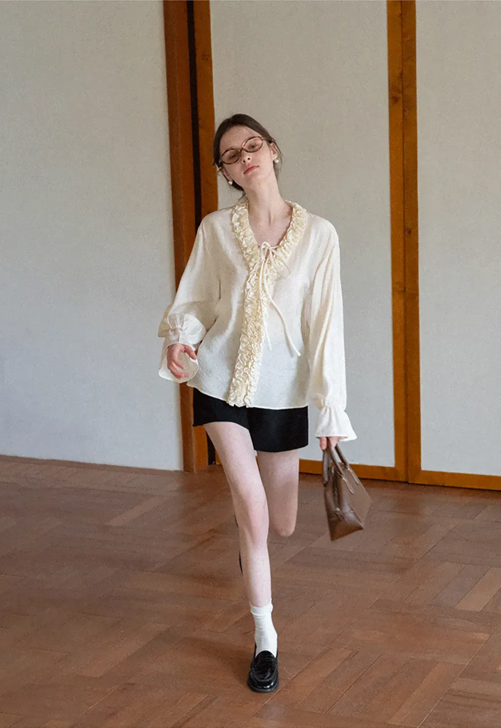 Long sleeve shirt with ruffled neckline and gathered cuffs