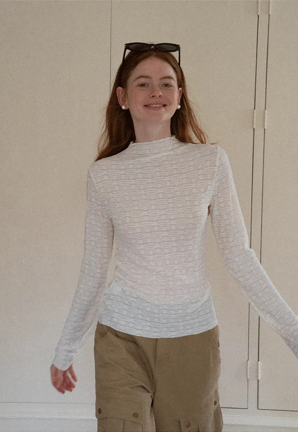 Elegant textured long sleeve top with subtle pattern design