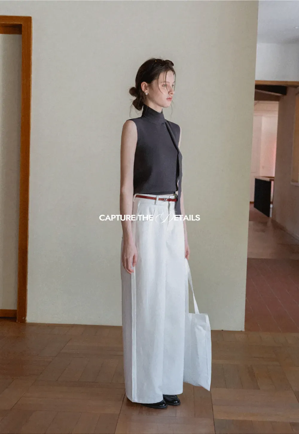 Sleeveless high neck knit top with side tie detail