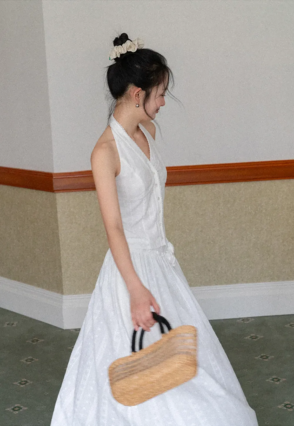 Halter neck sleeveless top with buttons and pleated skirt