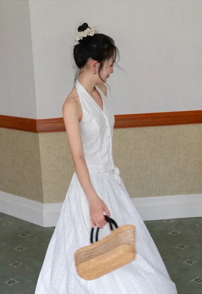 Halter neck sleeveless top with buttons and pleated skirt