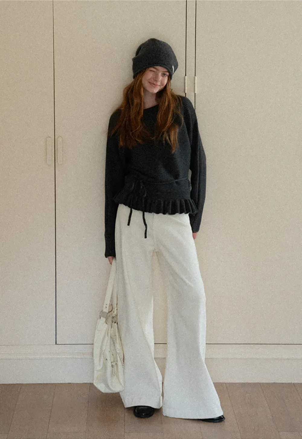 Ribbed knit sweater with tie back and flared hem design