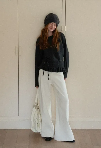 Ribbed knit sweater with tie back and flared hem design