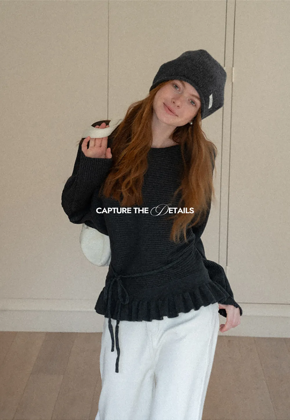 Ribbed knit sweater with tie back and flared hem design