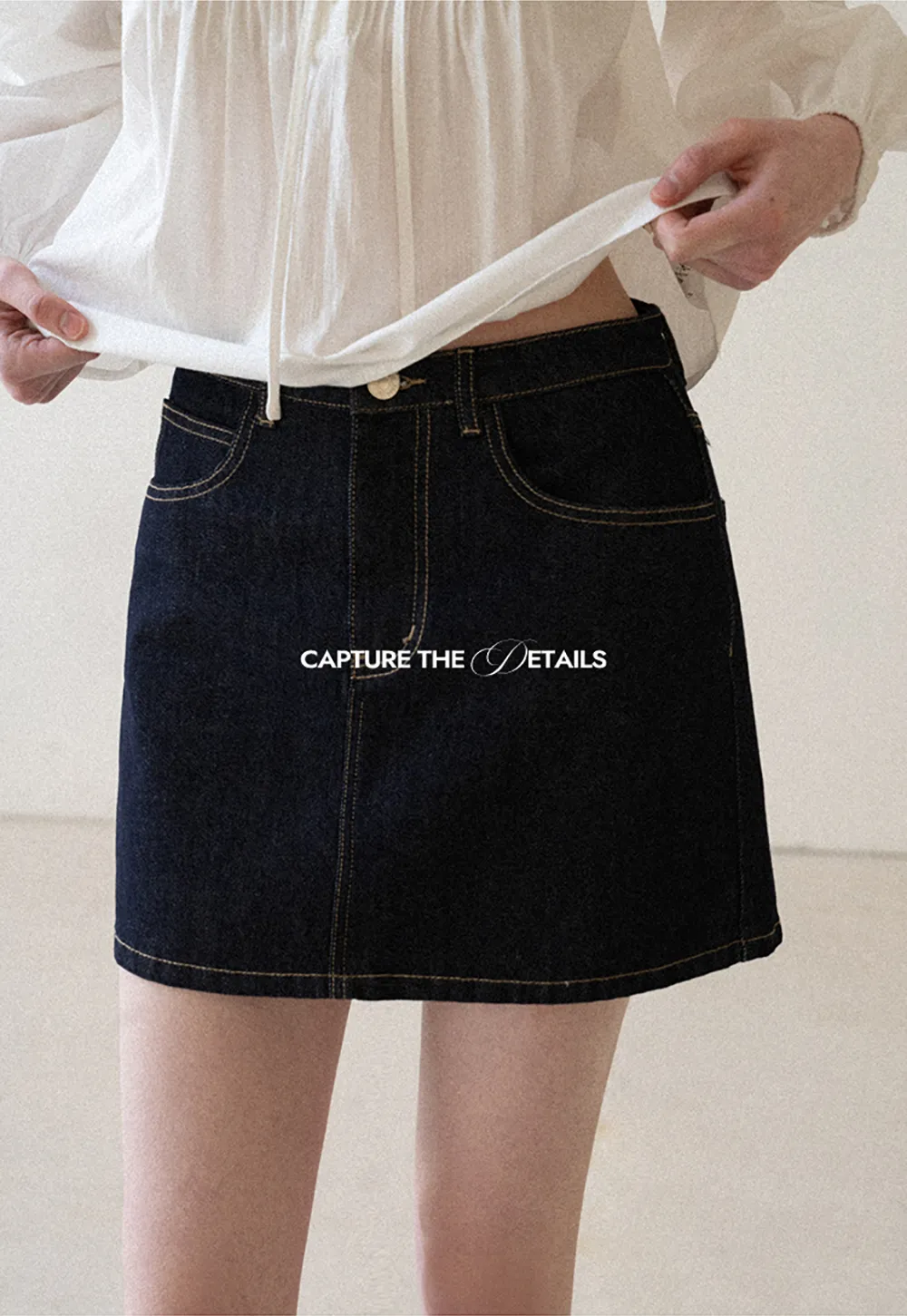 A-line denim skirt with front pocket design and adjustable waistband.