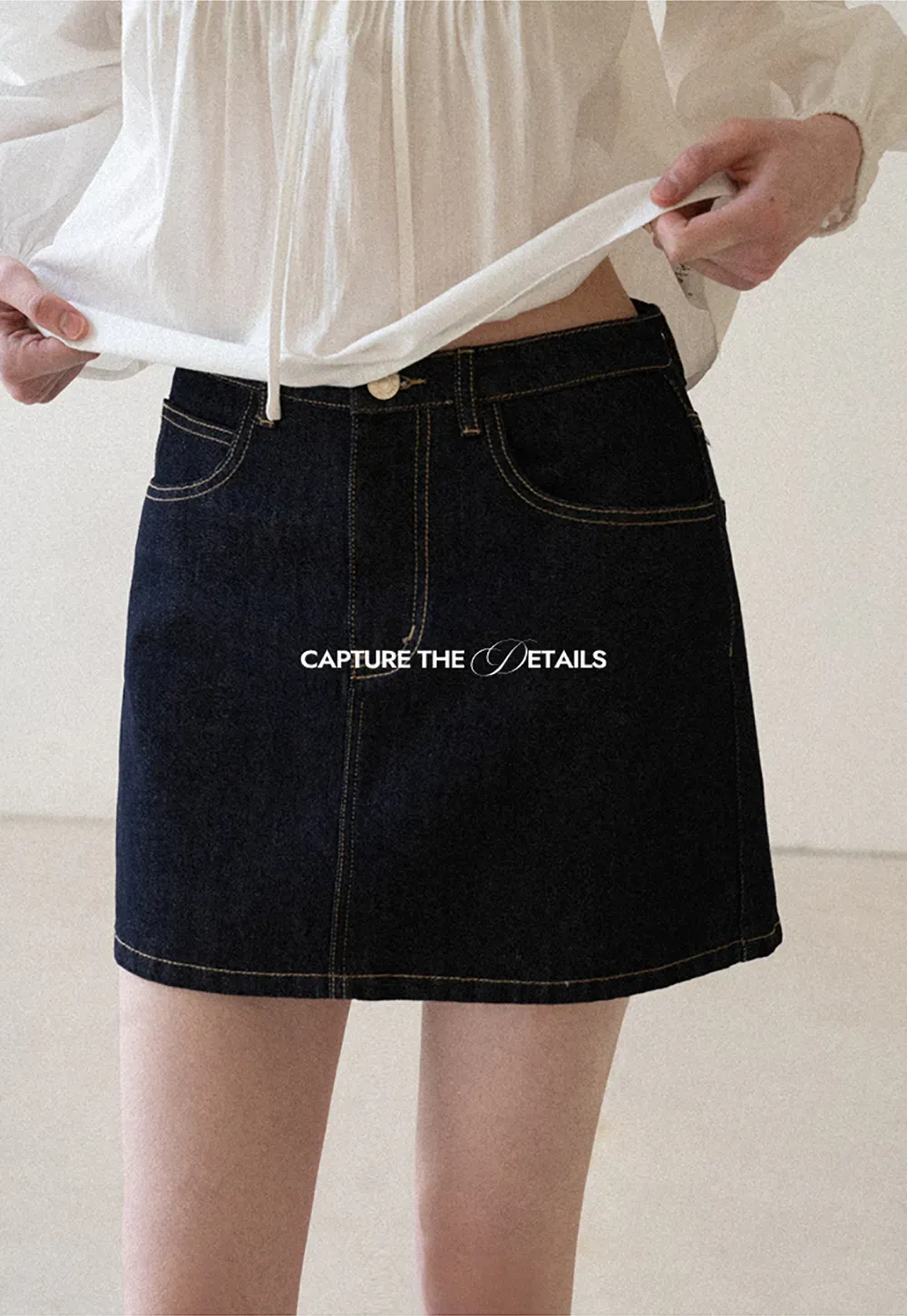 A-line denim skirt with front pocket design and adjustable waistband.