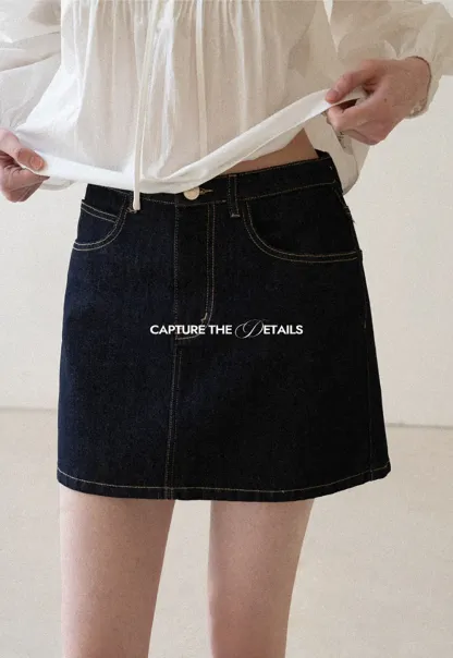 A-line denim skirt with front pocket design and adjustable waistband.