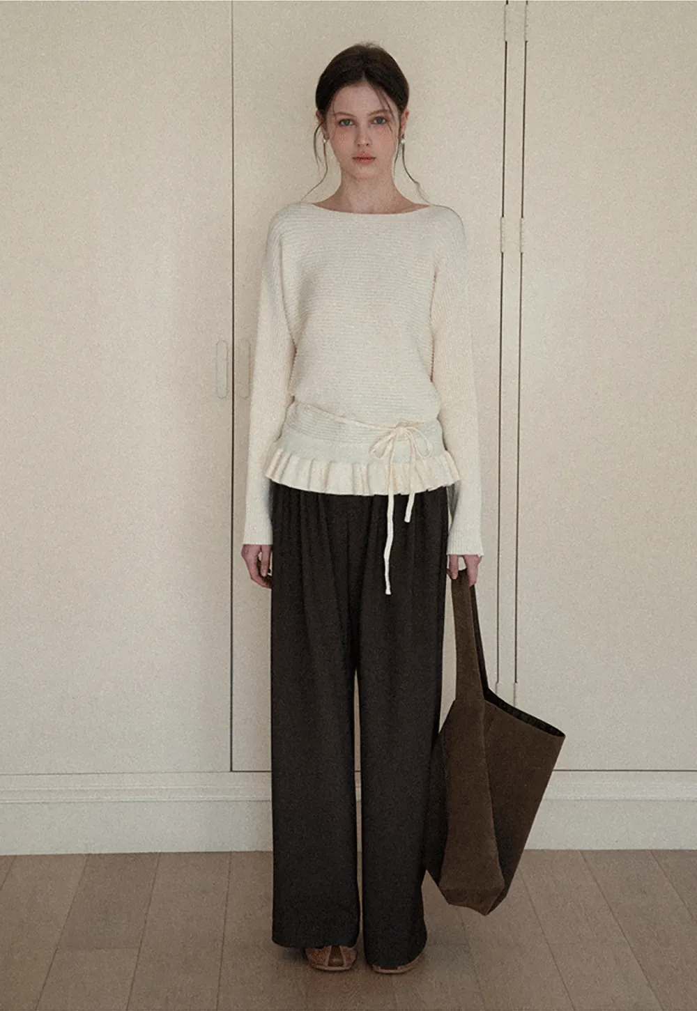 Ribbed knit sweater with tie back and flared hem design