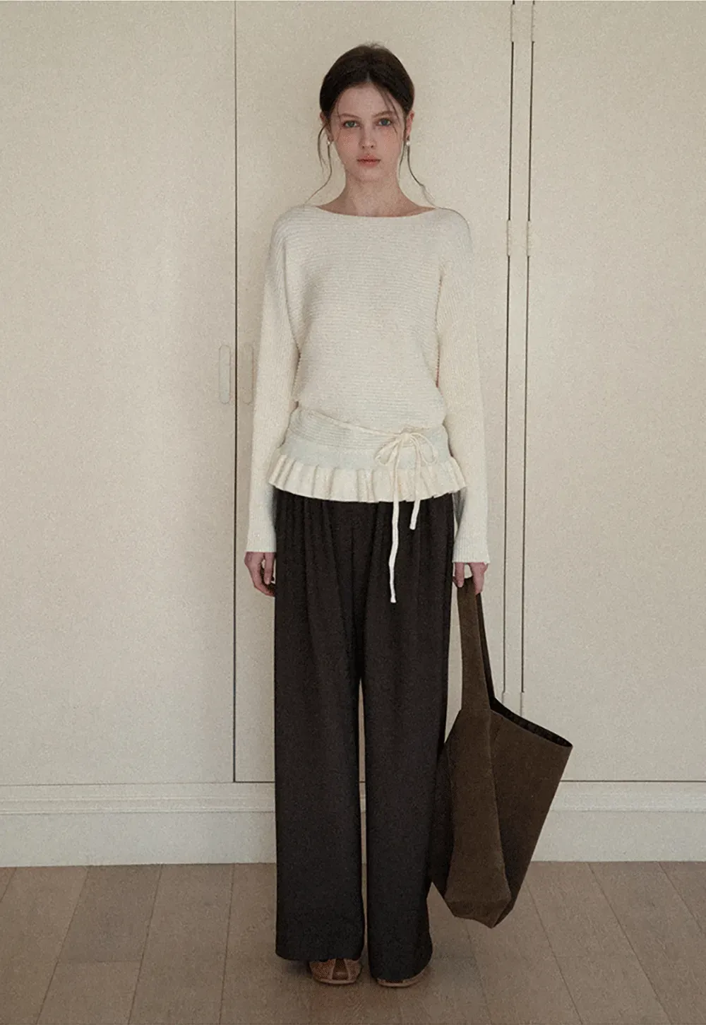 Ribbed knit sweater with tie back and flared hem design