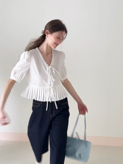 V neck short sleeve blouse with pleated hem and tie front