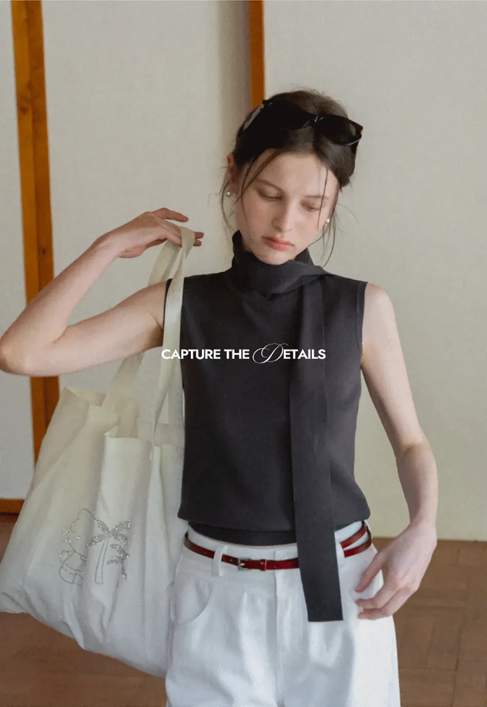 Sleeveless high neck knit top with side tie detail