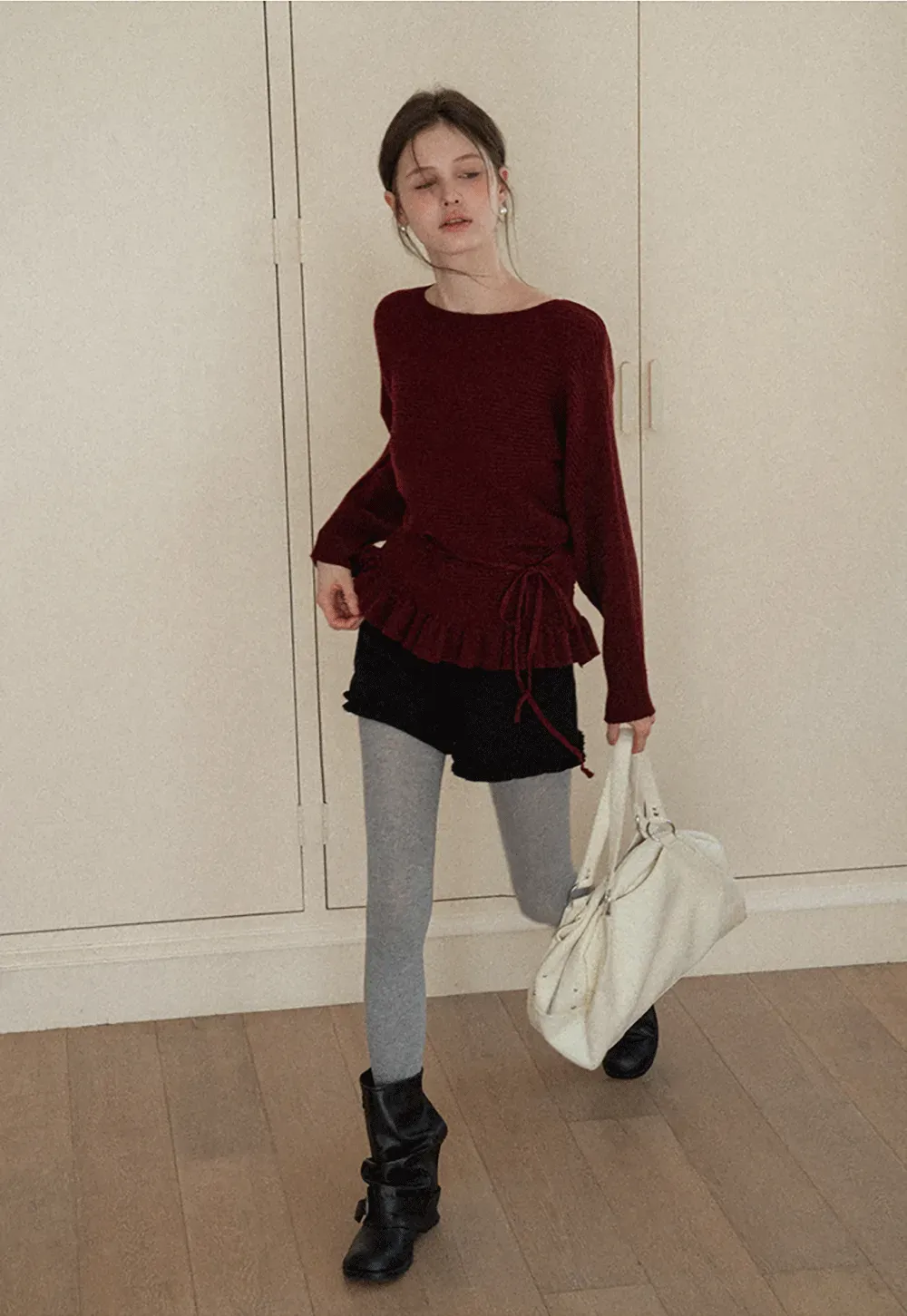 Ribbed knit sweater with tie back and flared hem design