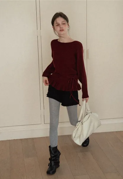 Ribbed knit sweater with tie back and flared hem design