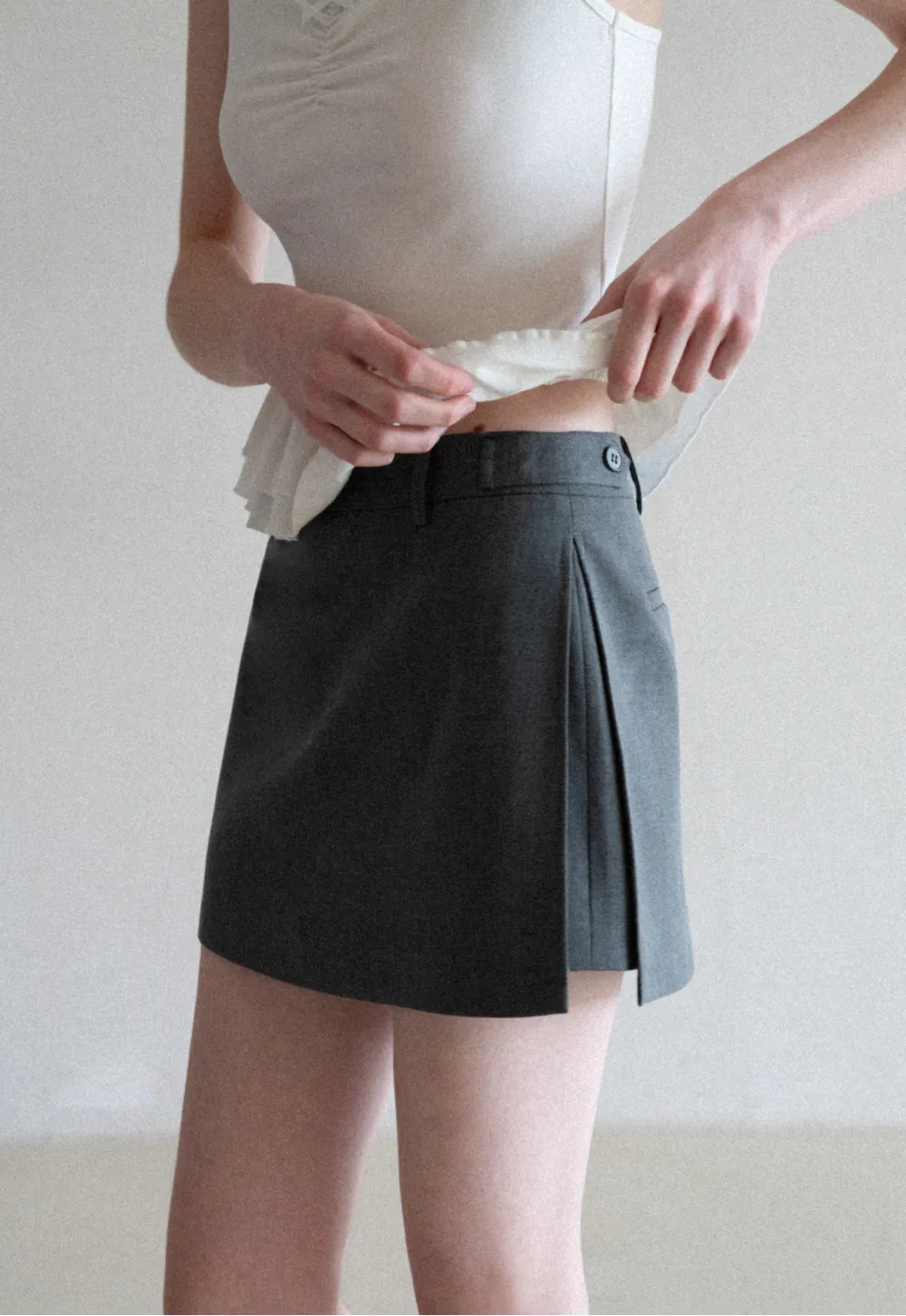 Elegant Pleated Mini Skirt with Asymmetrical Hem