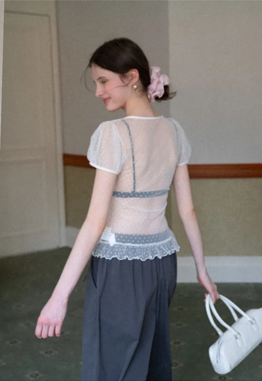 Sheer polka dot top with ruffled hem and puff sleeves