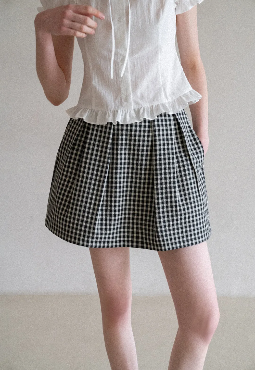 Plaid skirt with pleats and ruffled top